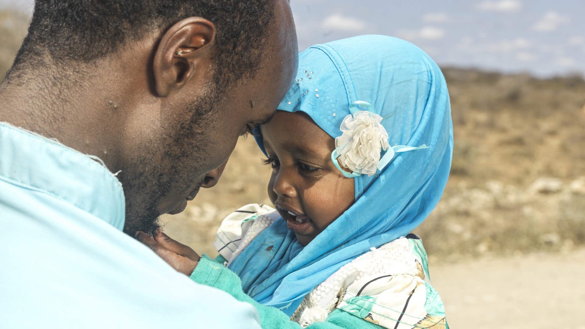 Isac holds his oldest child, daughter Munira, as they enjoy a special moment. 18-month-old Munira recently suffered from malnutrition and was treated by Action Against Hunger.