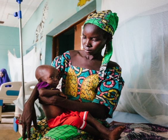 A mother and child inside one of Action Against Hunger’s Stabilization Centers in Nigeria, where conflict in the Northeast has pushed communities into a severe hunger crisis.