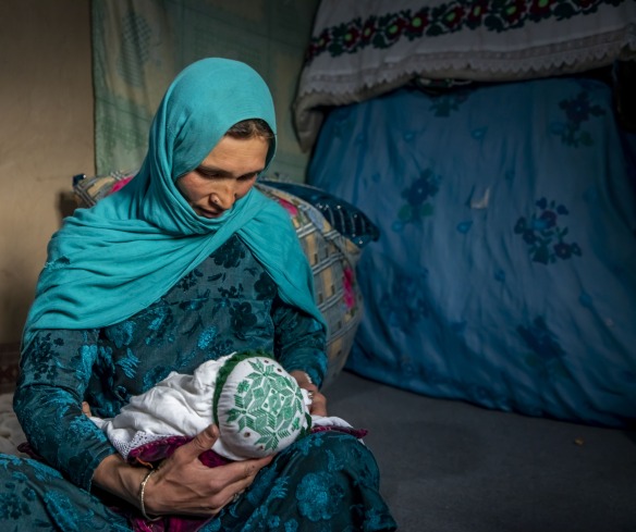 Nadia nurses her youngest child, 2 months old, at home in Duykondi Province, Afghanistan. Action Against Hunger works in this area to manage feeding programs and provide mobile health and nutrition support.
