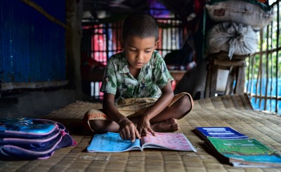 A boy studies in his home in Bangladesh.