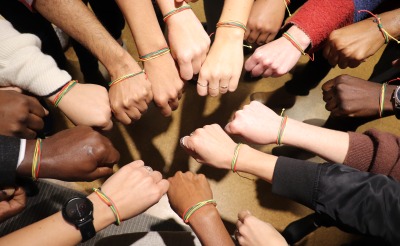 Members of Action Against Hunger's team in New York proudly show off their Band Together bracelets.