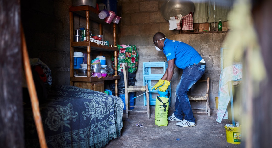 An Action Against Hunger team member disinfects a home after a suspected case of cholera was reported.
