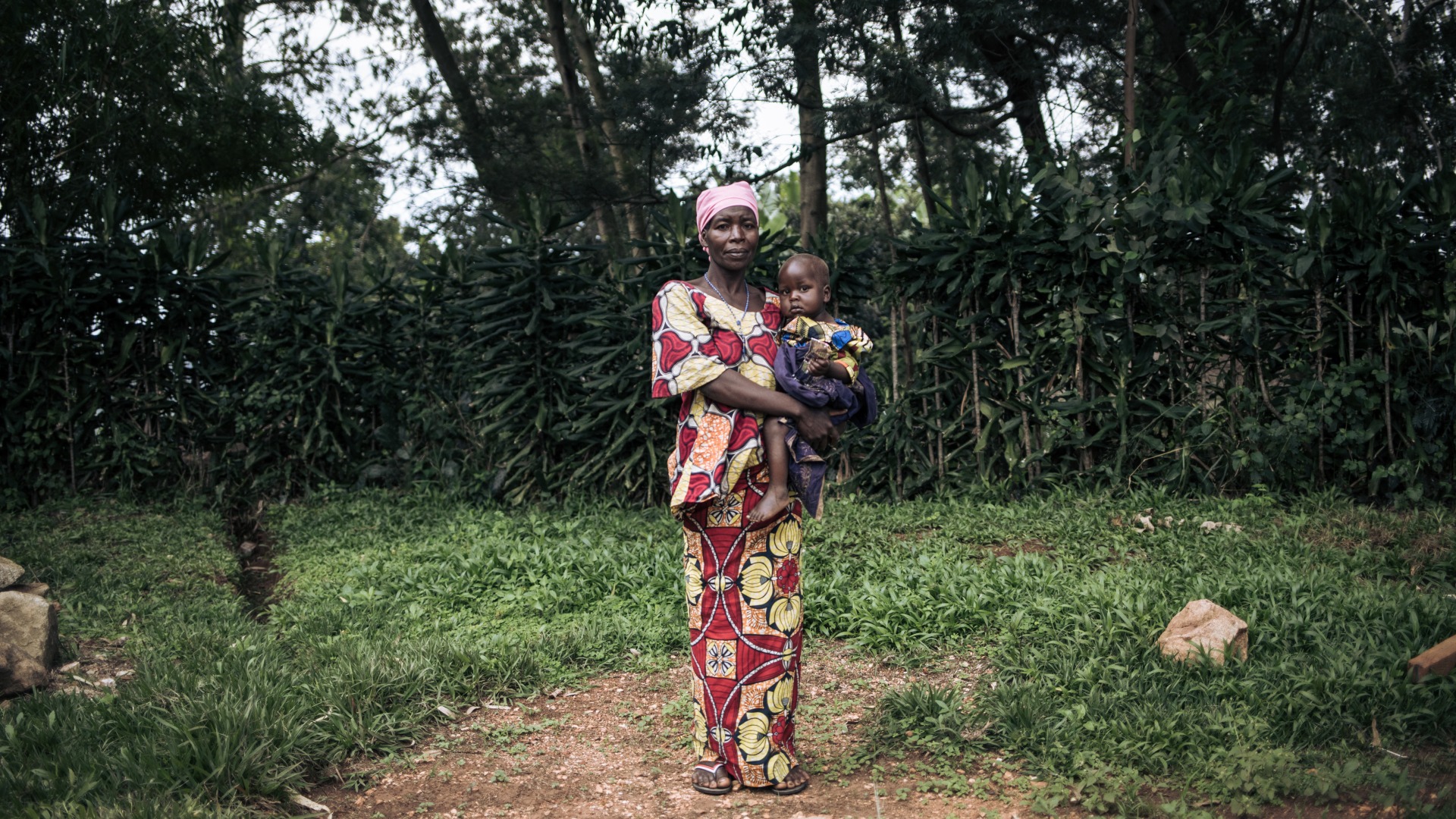 Georgine Dz'dha Nzale holds her 27-month-old son, David Wauba, who suffers from severe acute malnutrition, near the Drodro Health Center in Ituri, northeastern Democratic Republic of Congo.