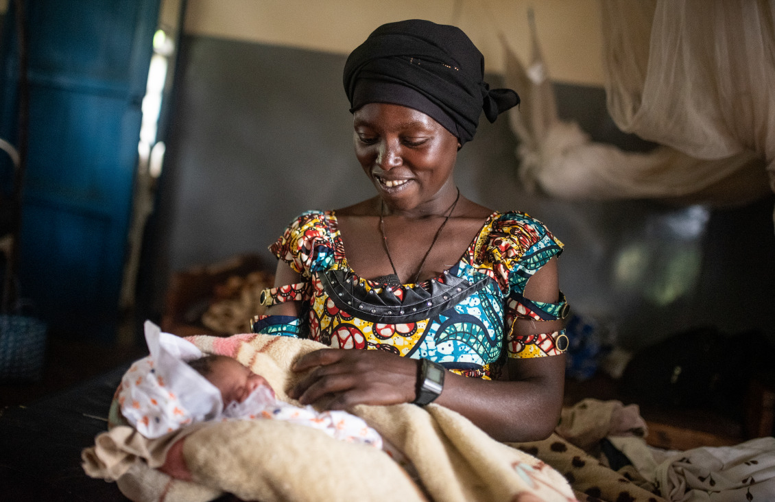 A woman holds her newborn baby.