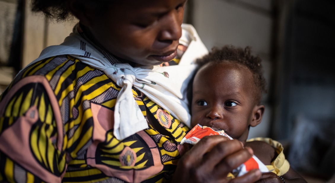 A mother feeds her child Plumpy'Nut, the peanut paste used to treat malnutrition.