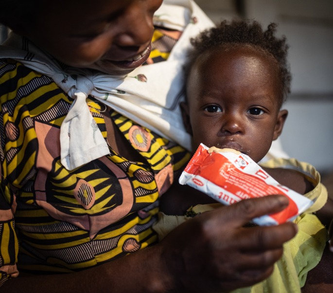 A mother feeds her child Plumpy'Nut, the peanut paste used to treat malnutrition.