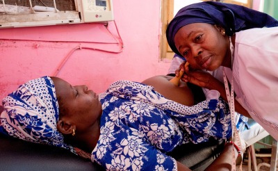 A health worker checks a pregnant woman's health