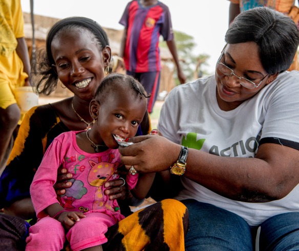 Dieymaba Niang sits while her daughter Kadia Diallo is fed ready-to-use therapeutic food to regain her health. Together, we can save lives and help children like Kadia not only survive - but thrive.