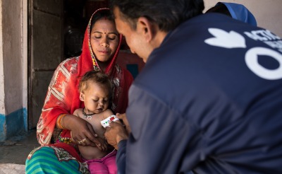 Community Health Worker Balram measures the mid-upper arm circumference of a three-year-old girl named Bhumika, and finds that she is severely malnourished.