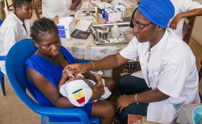 Health workers provide care to a mother and child in Ivory Coast.