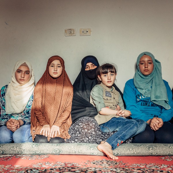 Mariam Agaghas, 47, a refugee sits in Irbid, Jordan, with her six daughters.