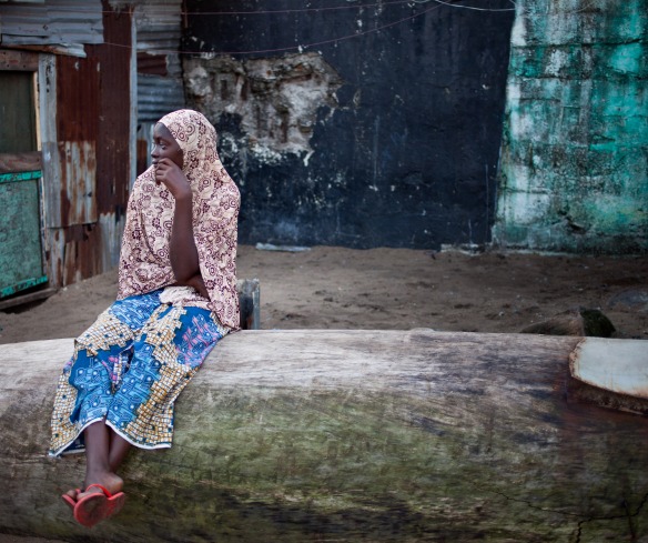 A woman sits in the West Point slum in Monrovia.