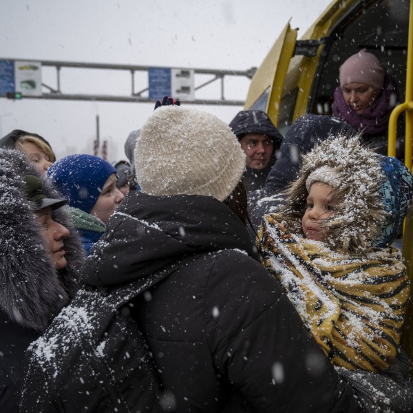 Ukrainian refugees face winter weather as they board a bus and cross the border into Moldova.