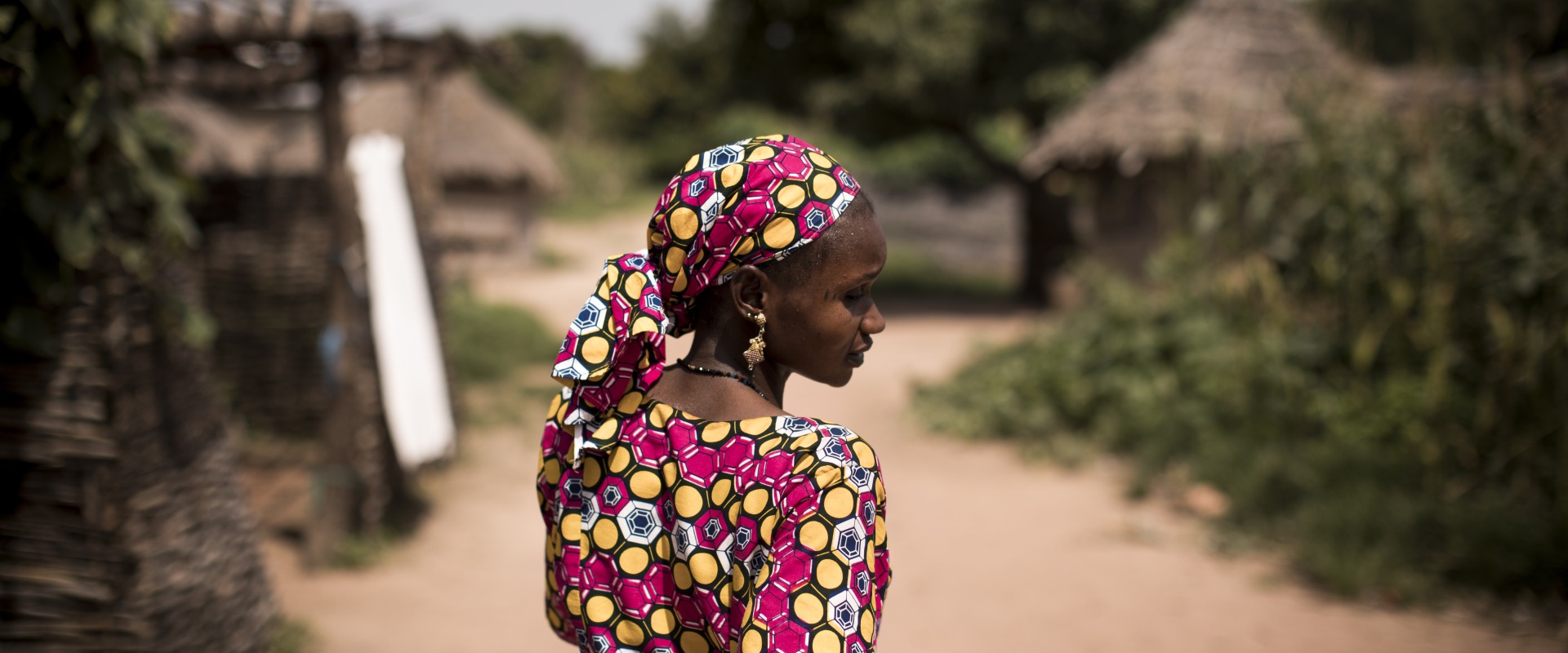 Hawa Coulibaly, 30, a community health worker walks in Kourougue village, Mali.