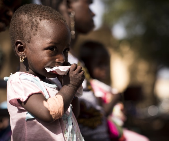 A girl eats Plumpy'Nut, the lifesaving ready-to-use therapeutic food that will help her recover from malnutrition.