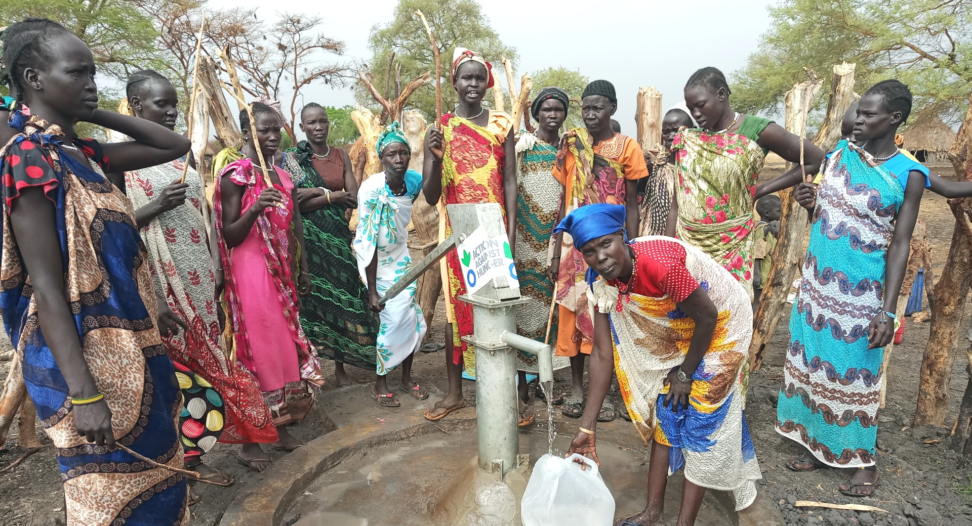 Women gather around a repaired water point in South Sudan.