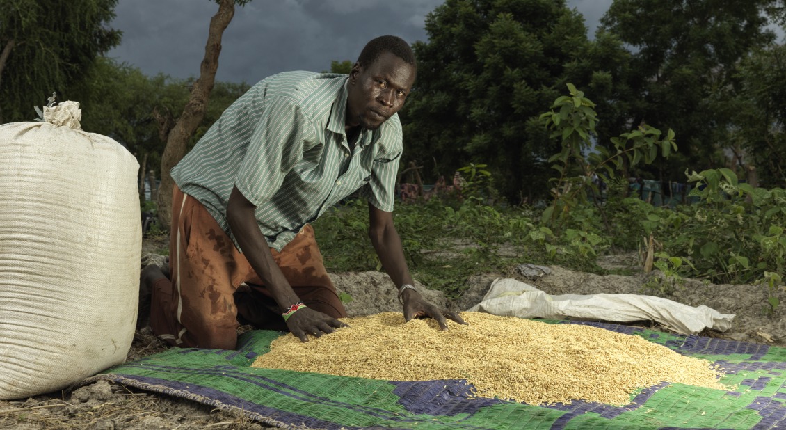 James Wuor, 50, with the rice he cultivated at home.